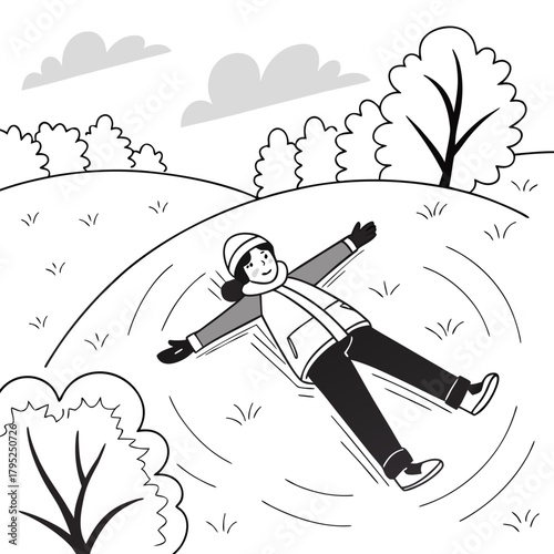 Child making a snow angel on a snowy hillside