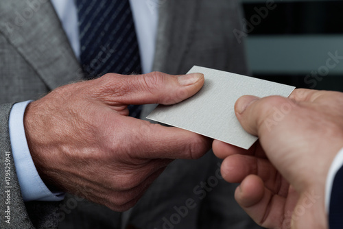 Close-up of business cards exchanged during meeting.