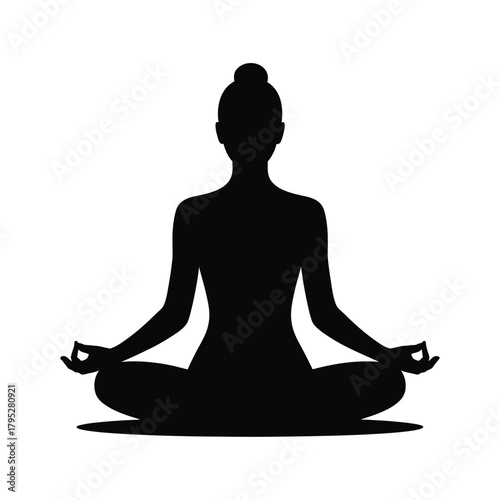 Silhouette of a person meditating in a lotus pose