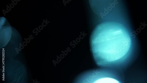 Abstract shimmering light leaks creating dreamy iridescent effects against a dark backdrop perfect for atmospheric visuals and creative projects