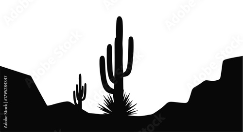 Silhouette of towering saguaro cacti against a vast desert landscape at dusk.
