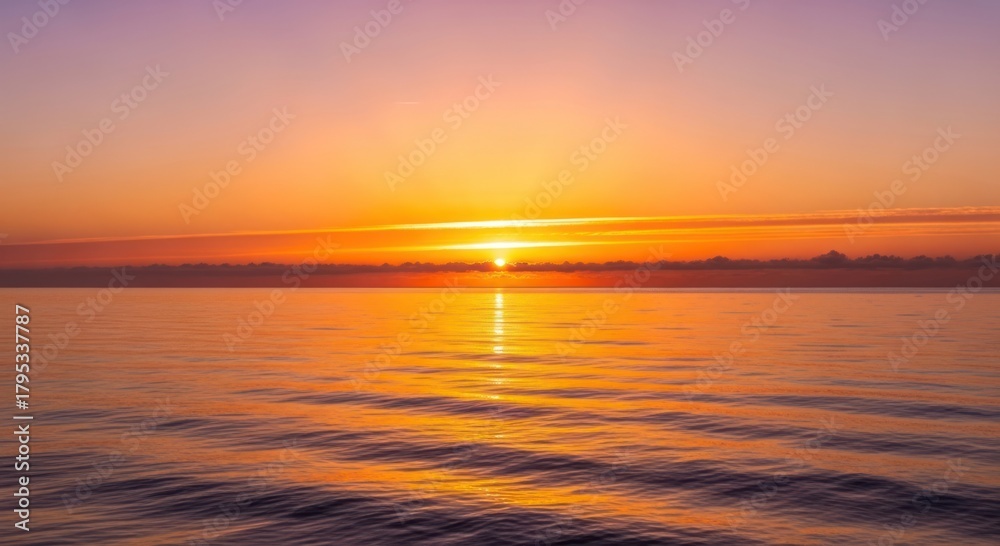 Obraz premium Vibrant Golden Sunset Over Calm Ocean Horizon with Reflective Water Surface