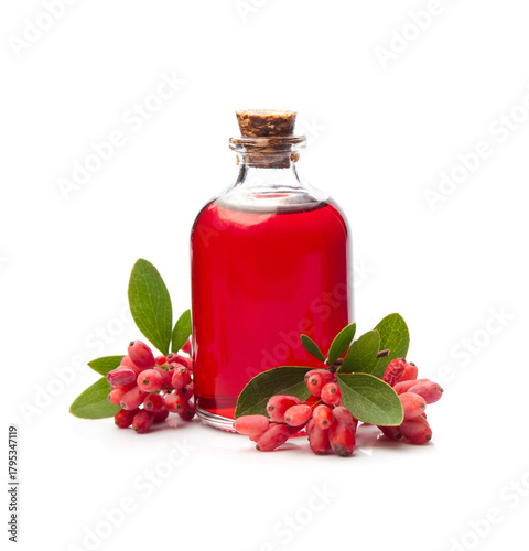 Barberry syrup in bottle and barberry berries