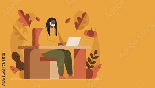 A man works on a laptop at a desk in a cozy autumnthemed environment Remote work concept