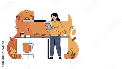 Woman reads a recipe on a tablet in a cozy autumn kitchen surrounded by fall leaves and pumpkins