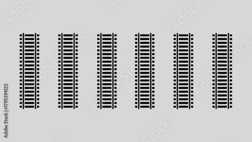 Captivating black railway tracks arranged in a clean, modern pattern against a neutral gray background, offering endless design possibilities for your projects.