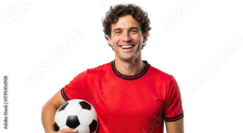 Smiling young man in red soccer jersey holding a classic black and white football isolated on transparent background