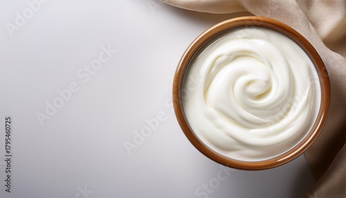 creamy greek yogurt in glass bowl on white background with copy space top view yogurt creamy white