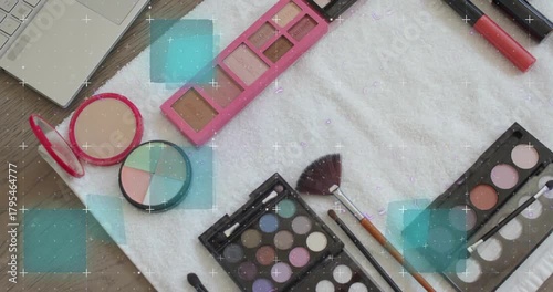 Turquoise squares appearing and blue scan lines sweeping across flatlay makeup revealing palettes