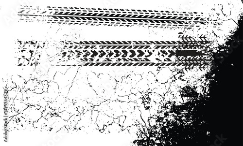 Close up abstract black tire tracks imprinted on a textured white surface with a dark shadowy edge