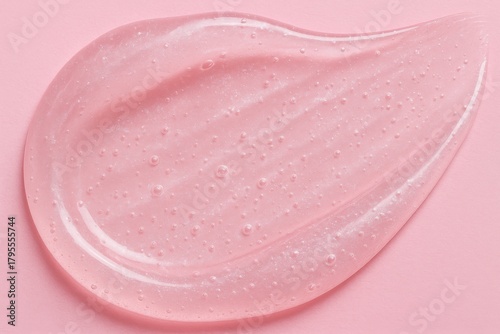 Close-up of shimmering pink gel with bubbles against a soft pink background. Concept of skincare, beauty products, and luxurious pampering.