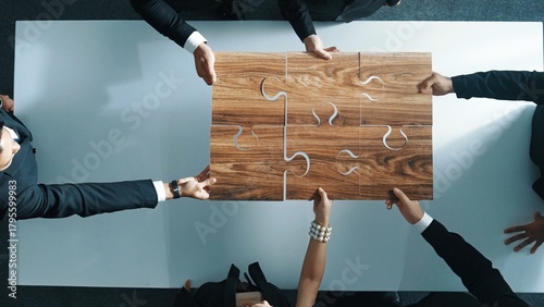 Top view of skilled businesspeople hand bring and fill the last jigsaw piece together. Group of project manager complete puzzle or solving problem. Unity, teamwork, successful project. Directorate.