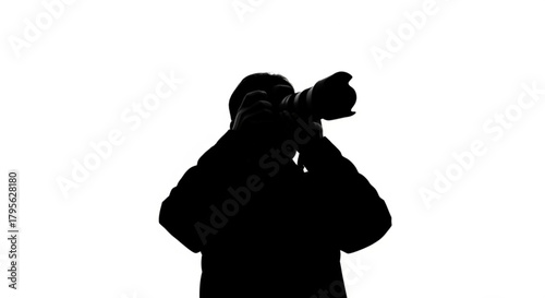 Silhouette of a photographer holding a camera with a long lens against a white background in a studio