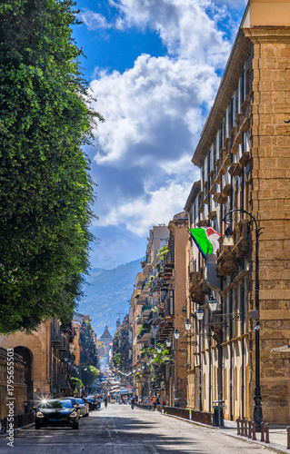 Palermo cityscape in Sicily, southern Italy. Glimpse of the Cassaro urban street: the Porta Nuova is in the background, historic citygate.