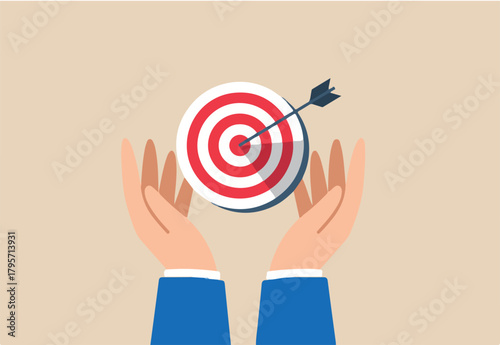 Businessman hand holds bullseye with arrow, illustrating aiming business target accurately. Concept of setting goals, focus and concentration to achieve success, pursuing objectives with purpose