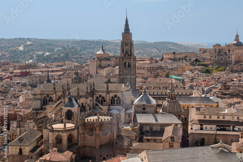 View of houses and rooftops with the tower and cathedral of Toledo, Spain.