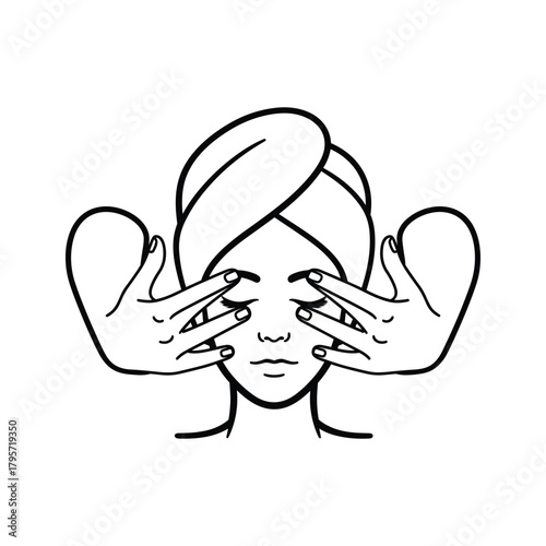Woman with towel on head receiving facial massage with hands covering eyes face