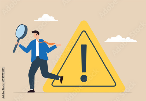 Businessman investigate incident with magnifier and exclamation sign