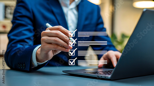 Person in blue suit using laptop with digital checklist overlay symbolizing task completion, productivity and business organization