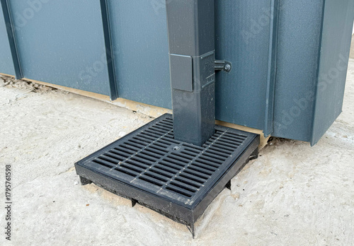 Photos Plastic rainwater gully with grate on concrete base