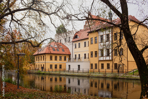View of the old town in Bydgoszcz, Poland, historic yellow houses by the canal, houses in the park, winter cityscape.