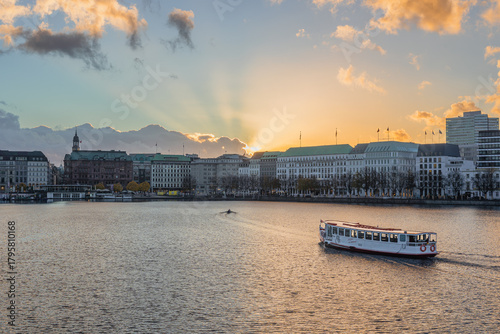 View of the Alster lake with an Alster steamer at golden hour