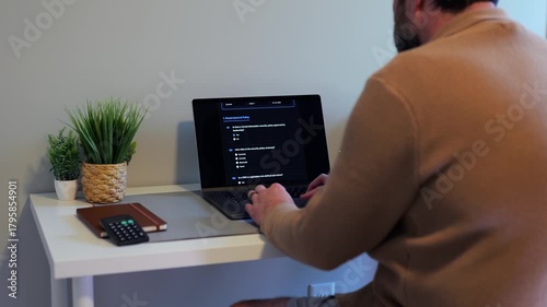 Middle Aged Man Working Remotely From Home Conducting Cybersecurity Audit for Consulting Firm - Information Security Concept