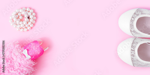 A creative, feminine, and girly backdrop. A pearl necklace folded into a circle, elegant white shoes, and a chic baby doll dress on a soft pink background.