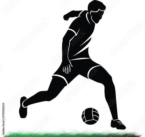Silhouette of a soccer player kicking a ball on grass