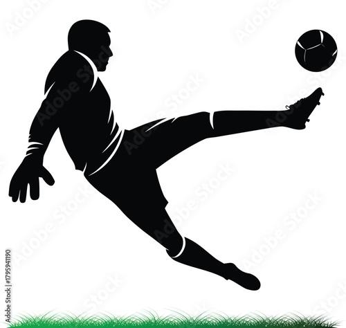 Soccer Player kicking the ball in mid air silhouette