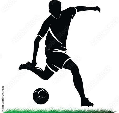 Soccer player silhouette kicking ball on green grass field