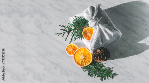 Collection of Christmas objects - gift box, frame, eve fir, dried orange, pine cone, star. New Year and winter minimal holiday frame composition. Flat lay, top view, place for text.