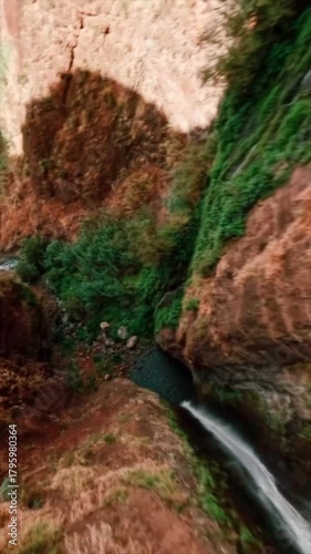 Beautiful and stunning sea view with strong waves and rocky beach taken with high speed fpv drone vertical view