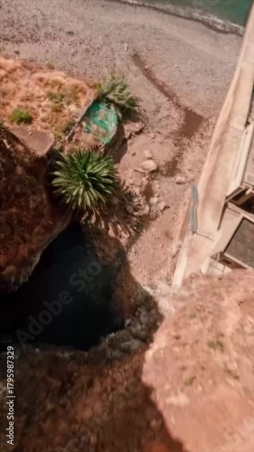 Stunning sea view with strong waves and rocky Beautiful beach taken with high speed fpv drone vertical view