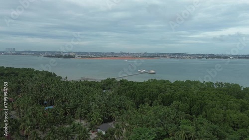 A Vast Coastal Drone Trip: Green Tropical Coastline Embraces Distant Dynamic Cityscapes