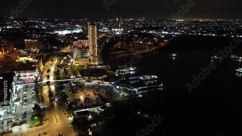Spectacular Night Cityscape Drone Footage Revealing a Tropical Urban Harbor and Glowing Skyline