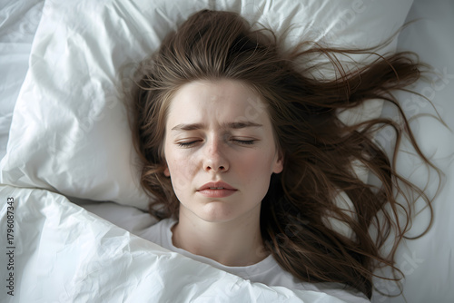 Tired sleepy woman. A tired sleepless woman with the pillow over her head. over white.