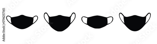 Collection of four black face masks with ear loops isolated on