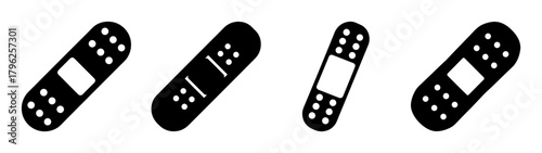 Set of four adhesive bandages with visible pads and perforated edges