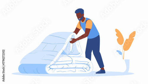 Man neatly folding folded soft, warm blanket or duvet at home, showcasing housekeeping and organization skills