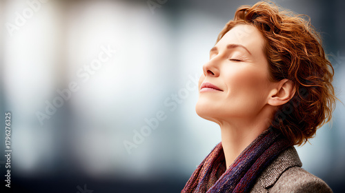 A serene woman enjoys a moment of tranquility, capturing a peaceful state of mind amidst a busy backdrop.