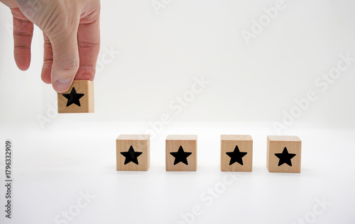 Hand Adding Star Rating on Wooden Blocks