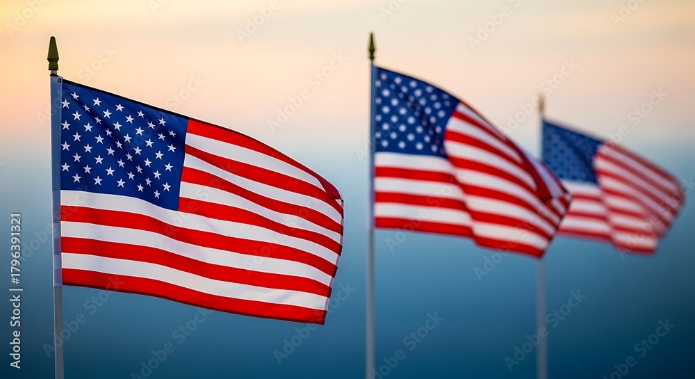 Fototapeta premium American flags waving in the wind against a clear sky at sunset