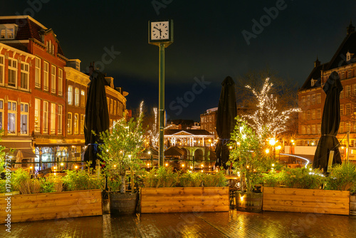 Illuminated Koornbrug bridge and clock square with Christmas lights in Leiden Netherlands at night