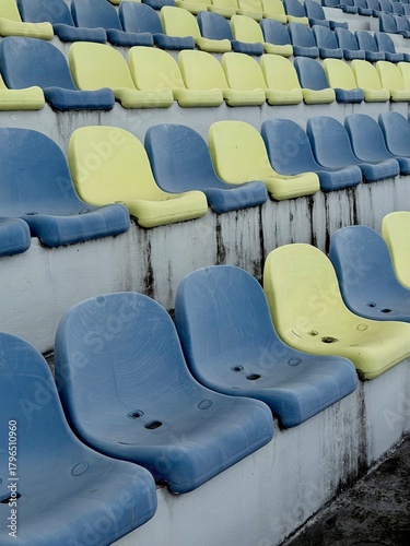  Blue and yellow seats in an outdoor stadium