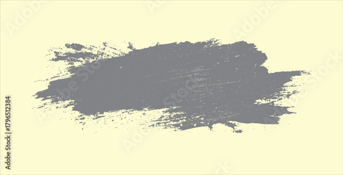 Textured gray paint brush stroke across a pale yellow background with distressed edges and speckles abstract
