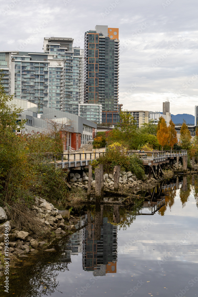 Fototapeta premium Urban Riverfront With Modern High-Rise Downtown and Wooden Walkway in New Westminster