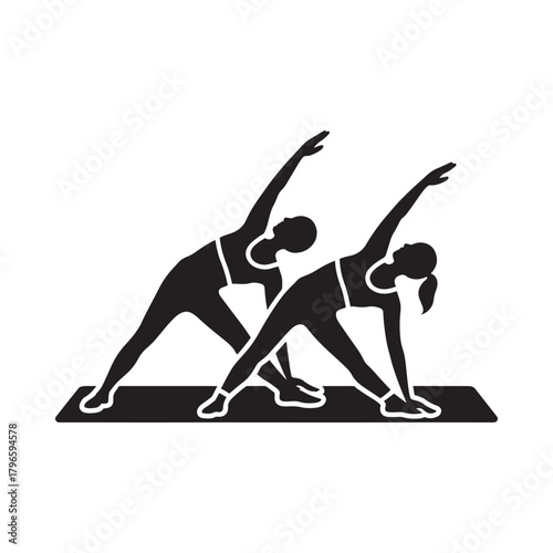 Two women performing triangle pose in yoga silhouette