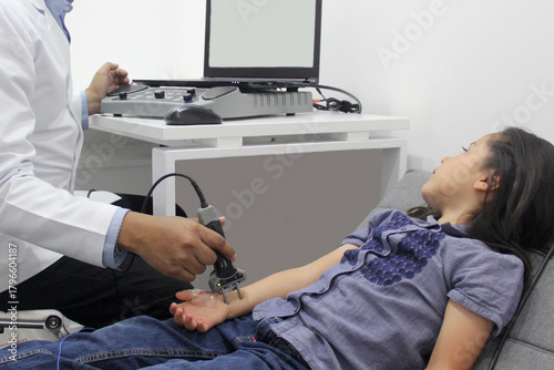 Electromyography EMG and Nerve Conduction Velocity NCV of the hand and arm in a 6-year-old Latina girl with a doctor