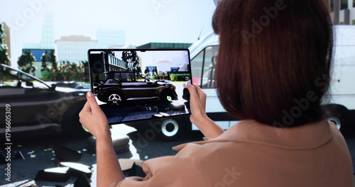 Insurance Adjuster Using Tablet To Photograph Car Damage